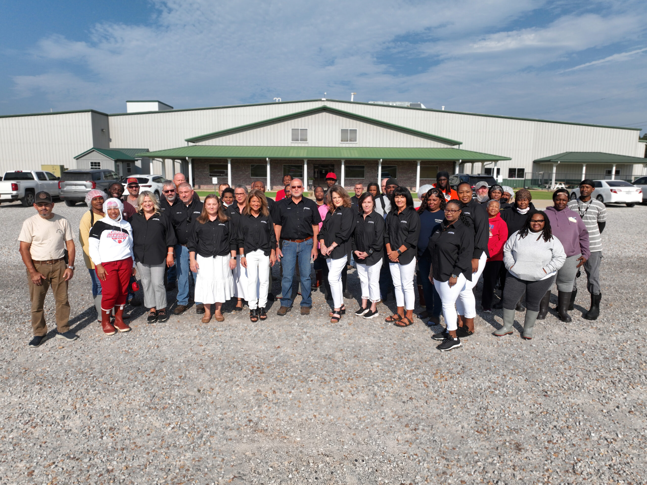 Superior Catfish staff standing infront of a building.